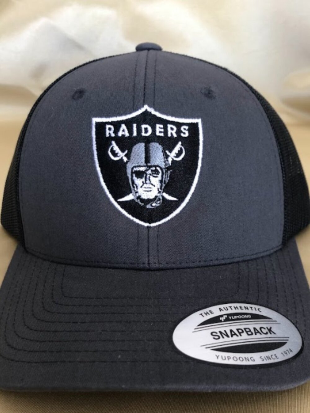 Las Vegas Raiders Grey with Black Mesh Trucker Snapback Hats!